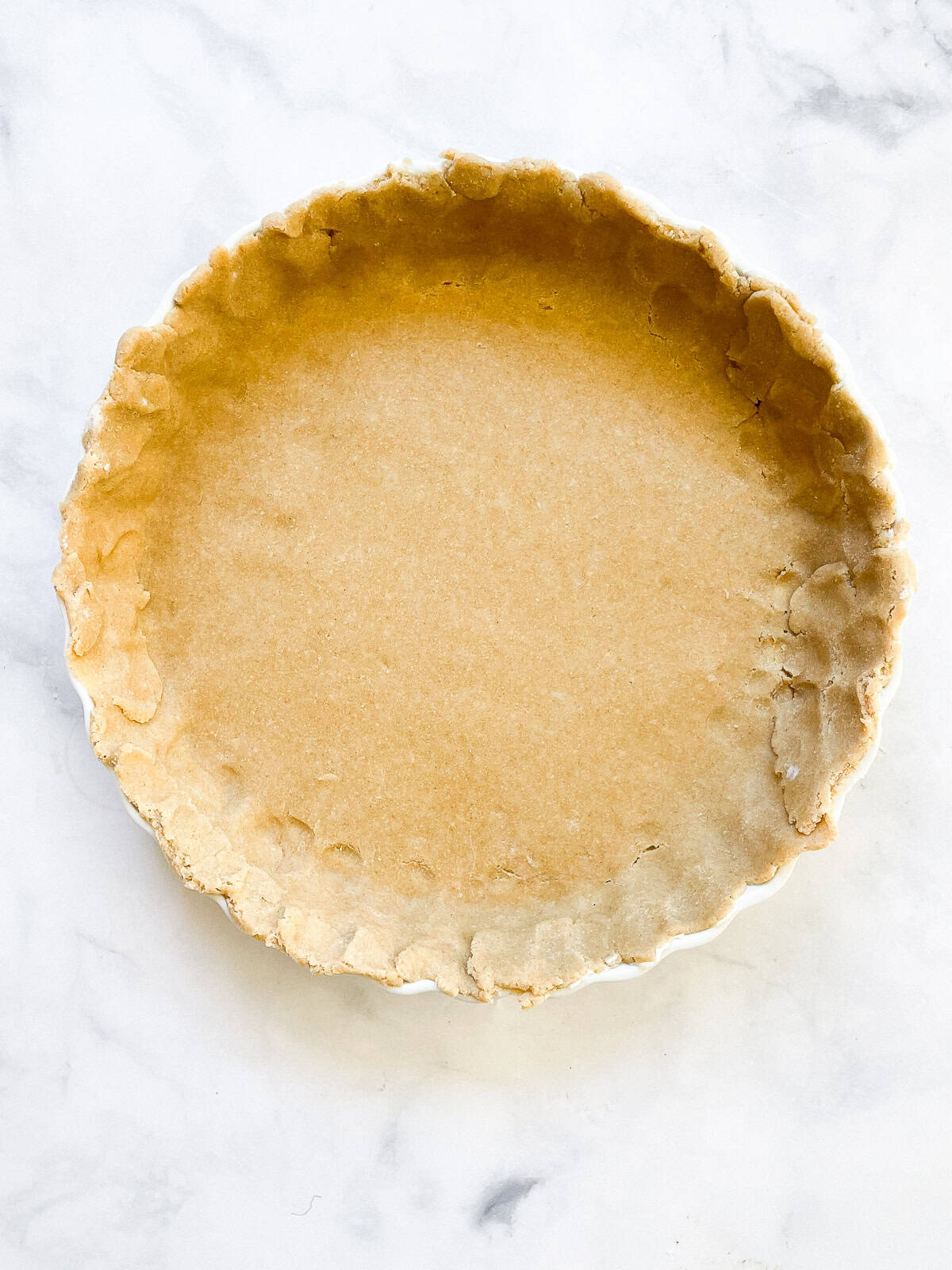 A gluten free all butter pie crust in a pie pan.