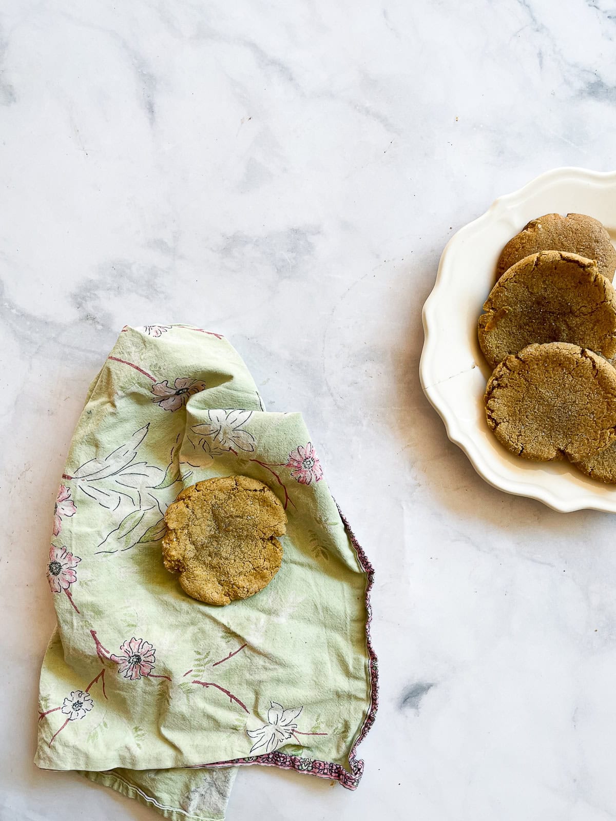 A chewy pumpkin cookie on a green napkin.