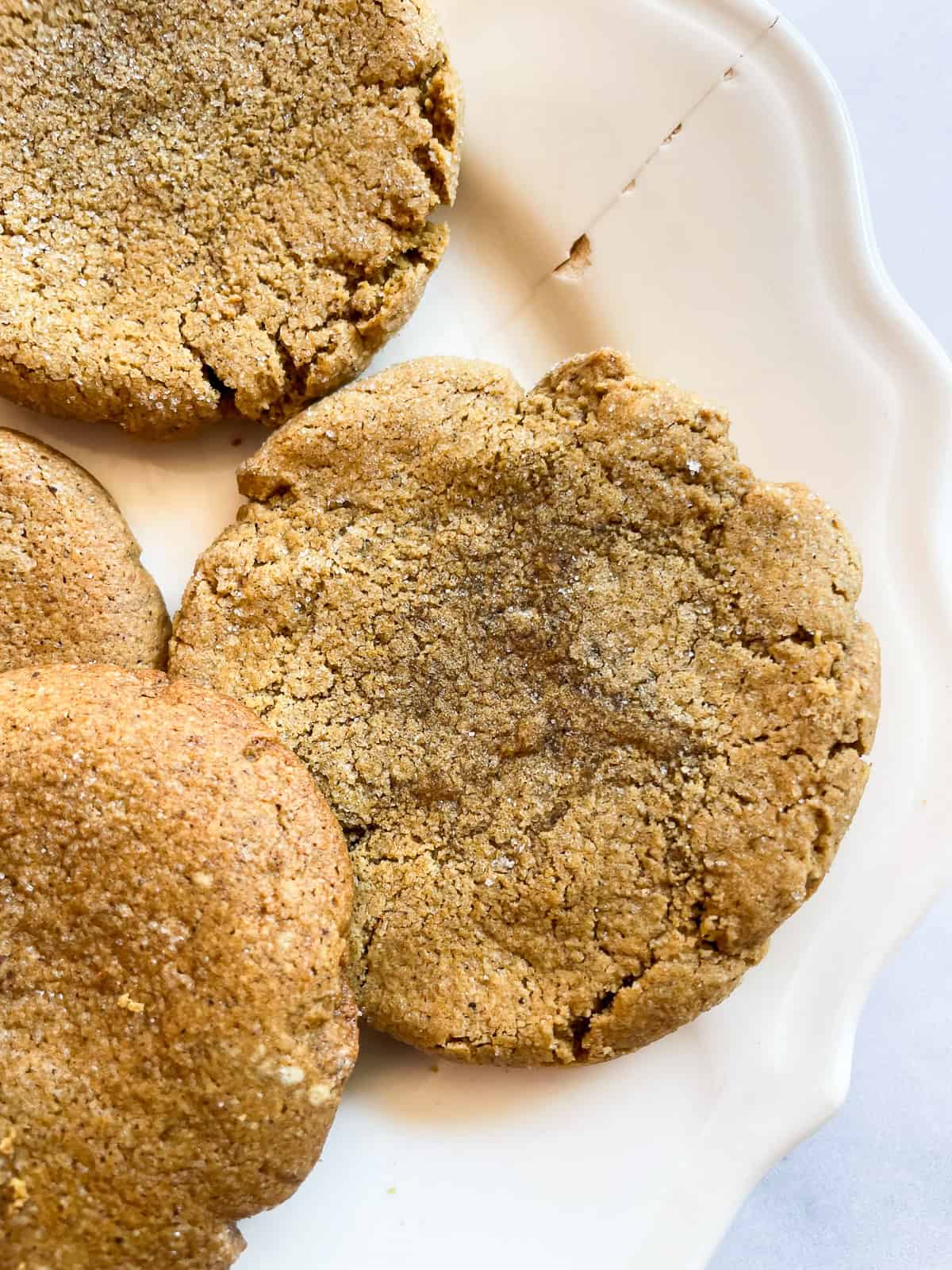 A few chewy pumpkin cookies on a plate.