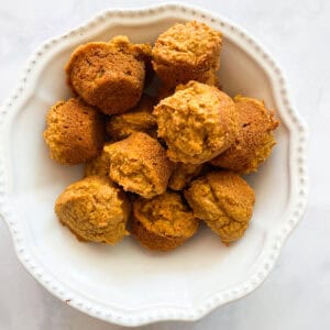 A bowl of gluten free mini pumpkin muffins.