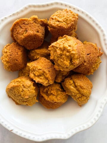 A bowl of gluten free mini pumpkin muffins.