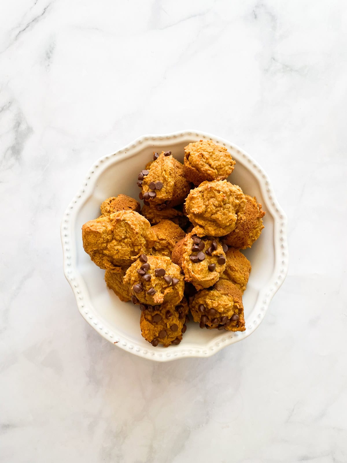 Chocolate chips on a few mini pumpkin muffins.