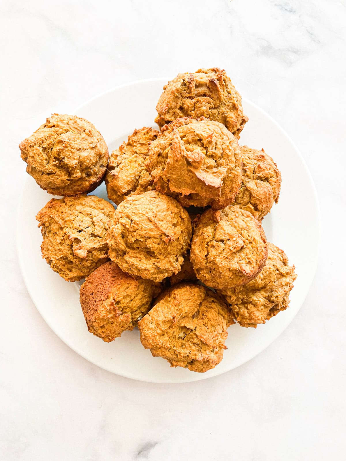 A plate of gluten free pumpkin banana muffins.