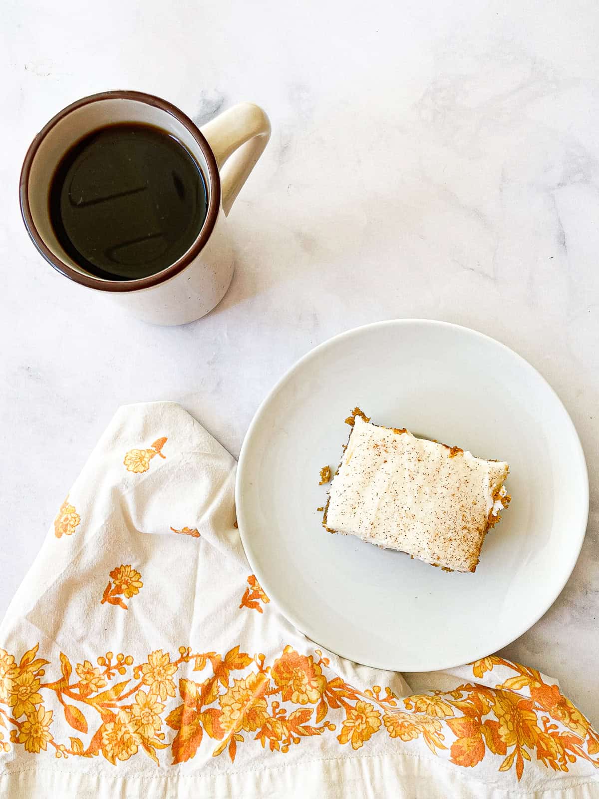 A cup of coffee and a gluten free pumpkin bar.