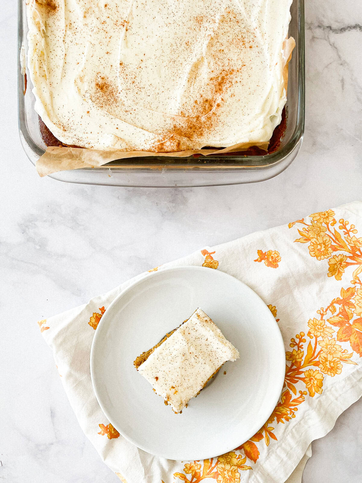 A tray of gluten free pumpkin bars and a bar on a plate next to a colorful napkin.