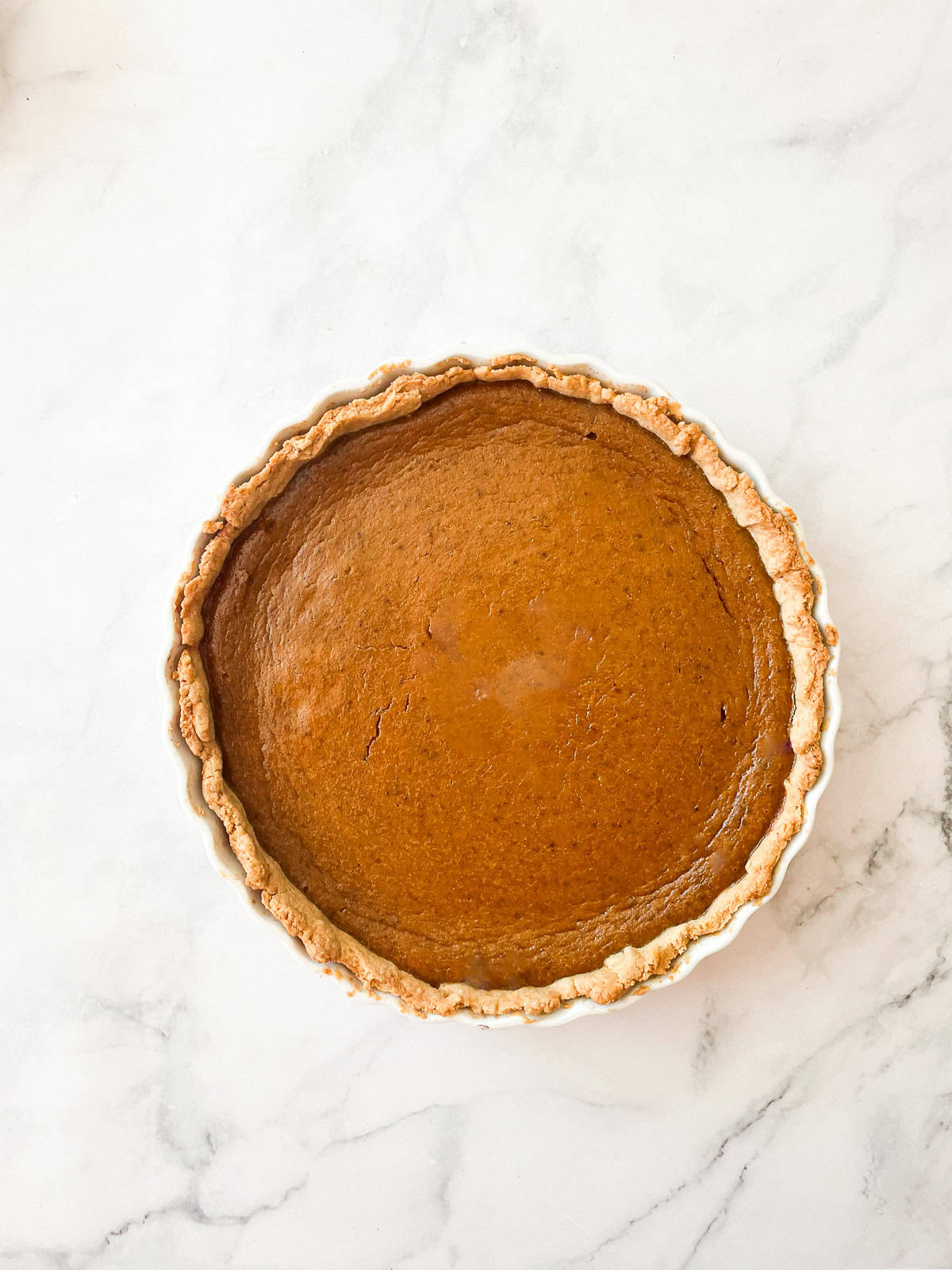 A gluten free pumpkin pie on a counter.