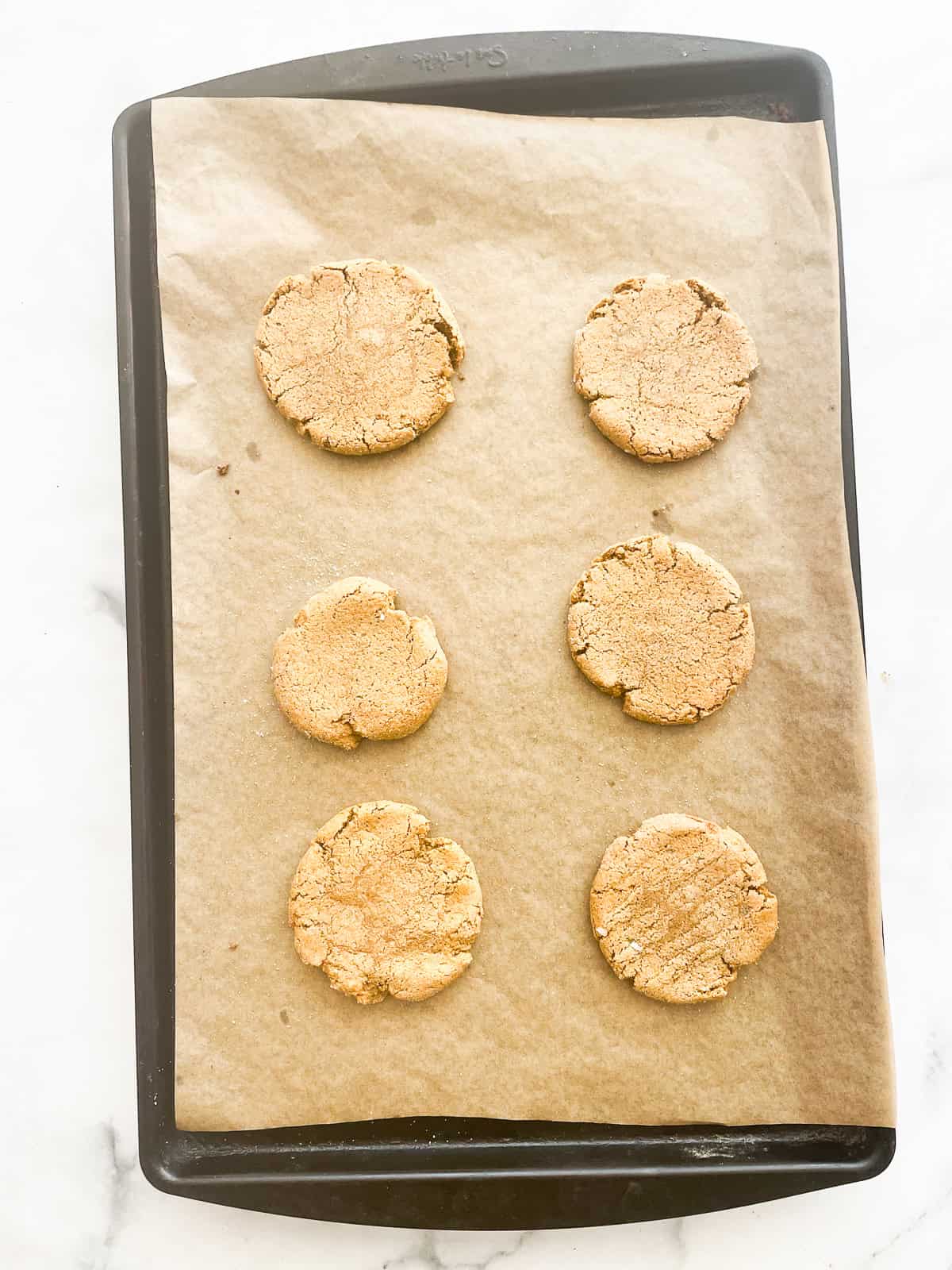 Baked chewy gluten free pumpkin cookies on a baking sheet.