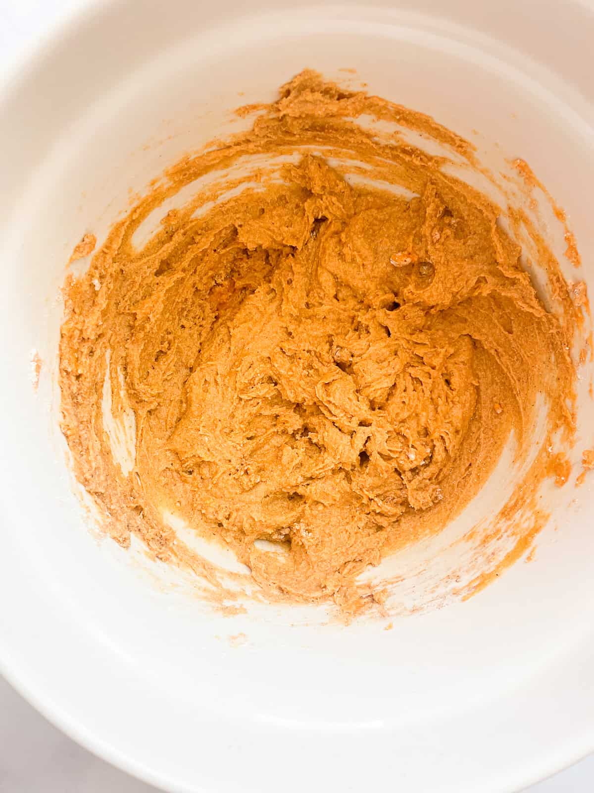 Batter for gluten free mini pumpkin muffins in a bowl.