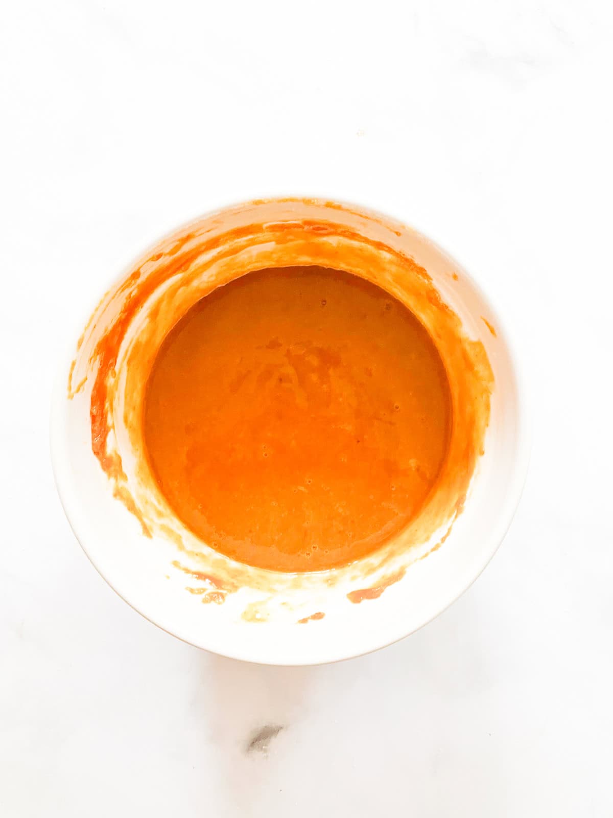 Pumpkin is combined with other ingredients in a bowl.