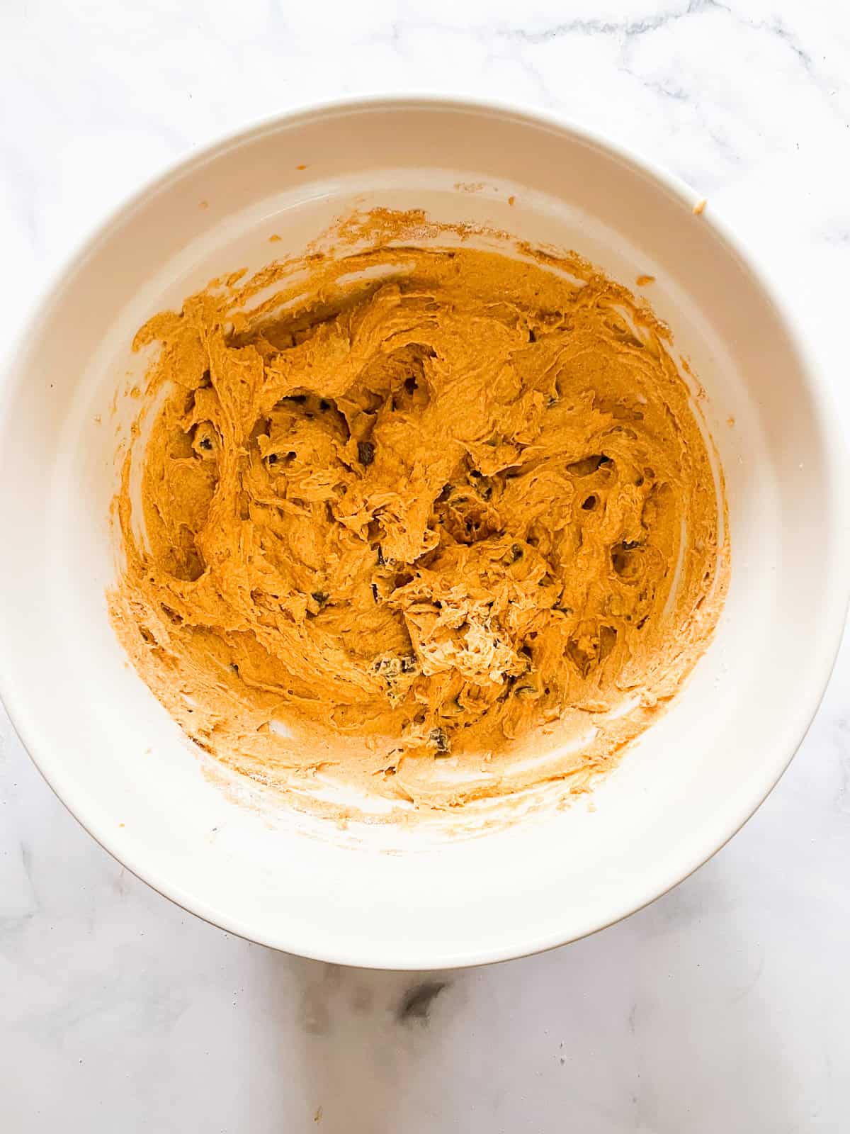 Gluten free pumpkin chocolate chip muffins batter in a bowl.