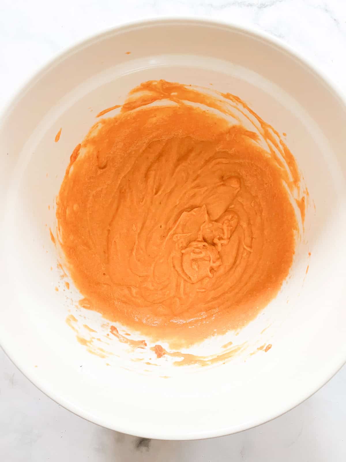 Pumpkin is added to pumpkin muffins batter.