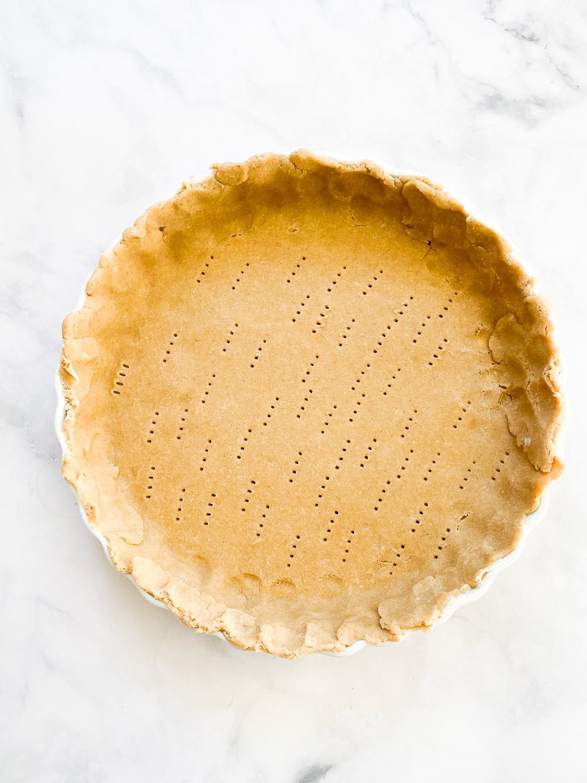 A gluten free pie crust in a pie pan.