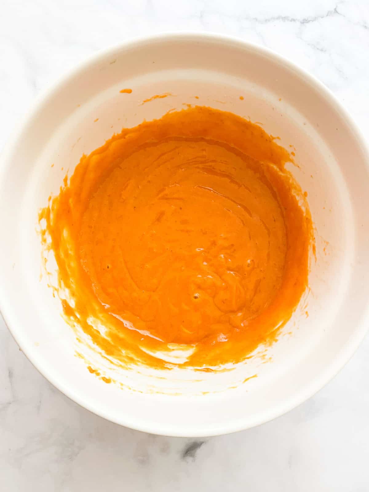 Wet mix for pumpkin sheet cake in a bowl.