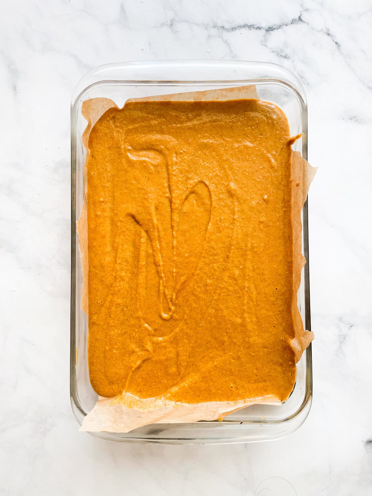 Pumpkin sheet cake batter in a pan.