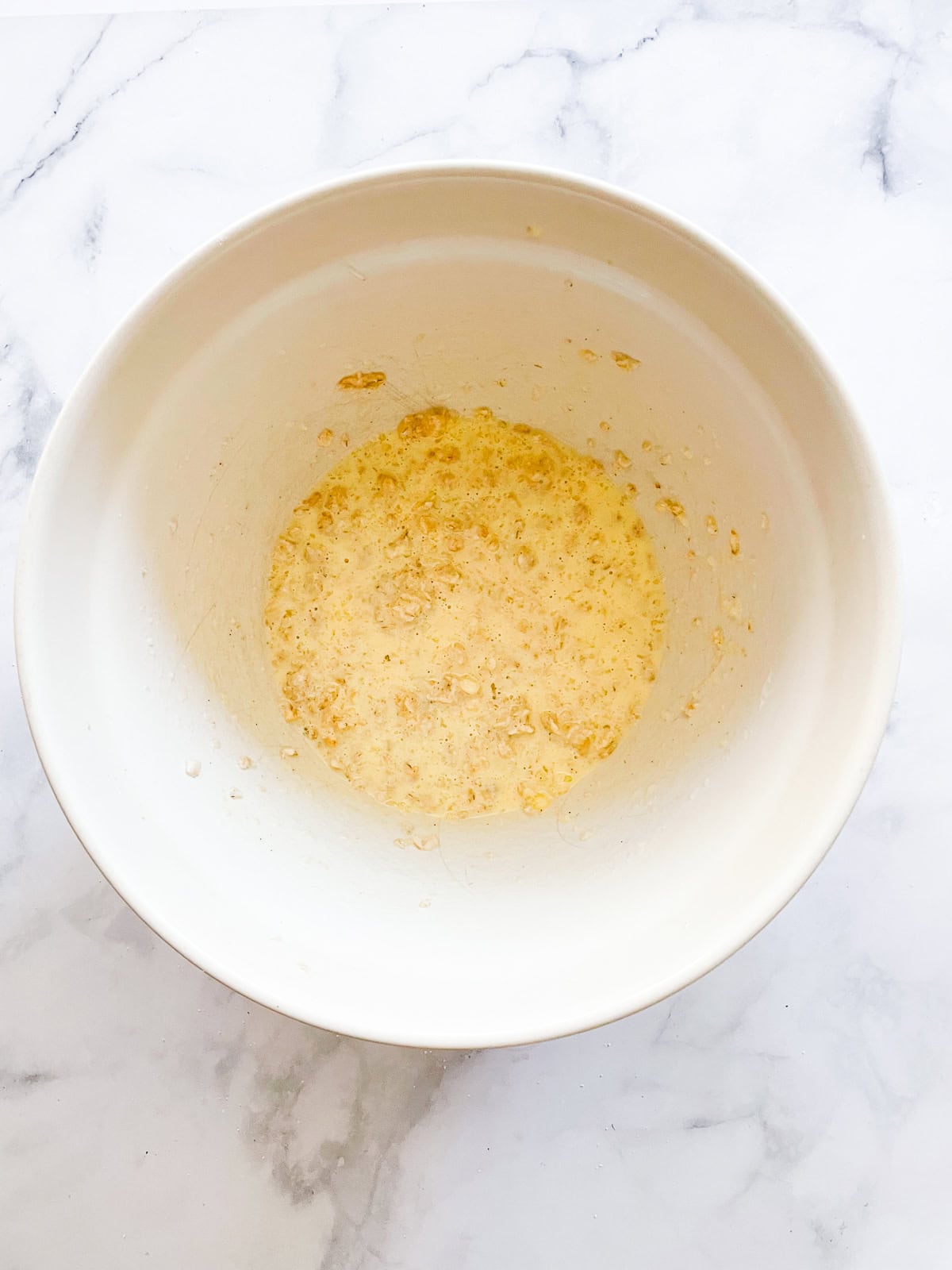 Wet mix in a bowl for leftover oatmeal muffins.