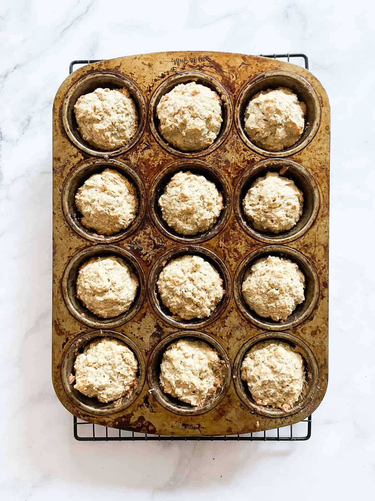 Oatmeal muffins cool in a tin.