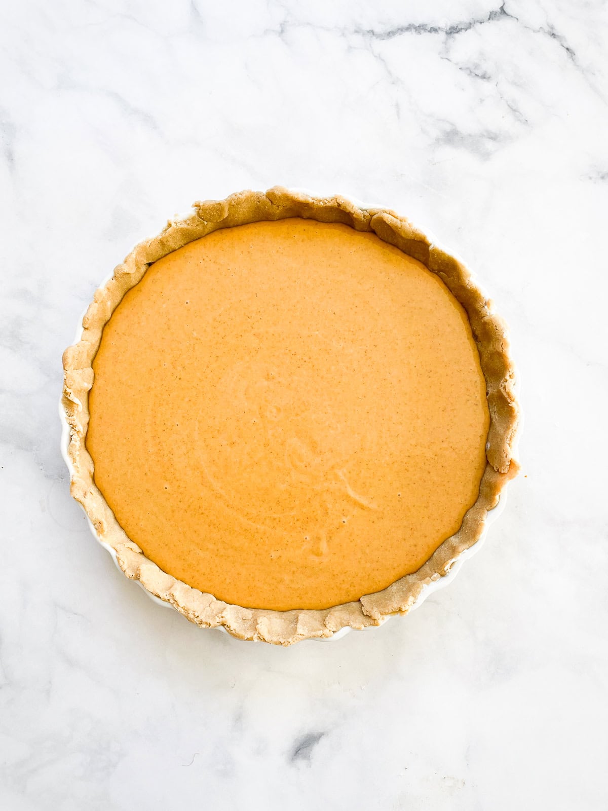 Maple pumpkin pie filling in a pie crust.