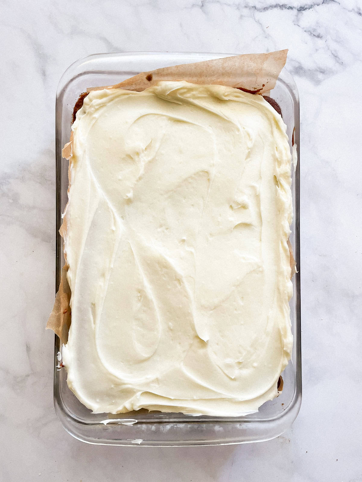 Cream frosting on top of the baked pumpkin bars.