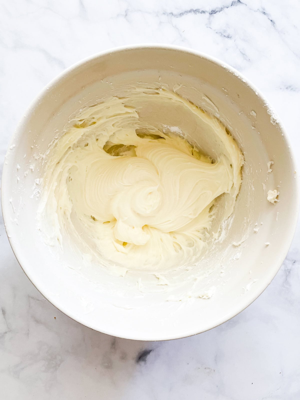 Cream cheese frosting in a bowl.