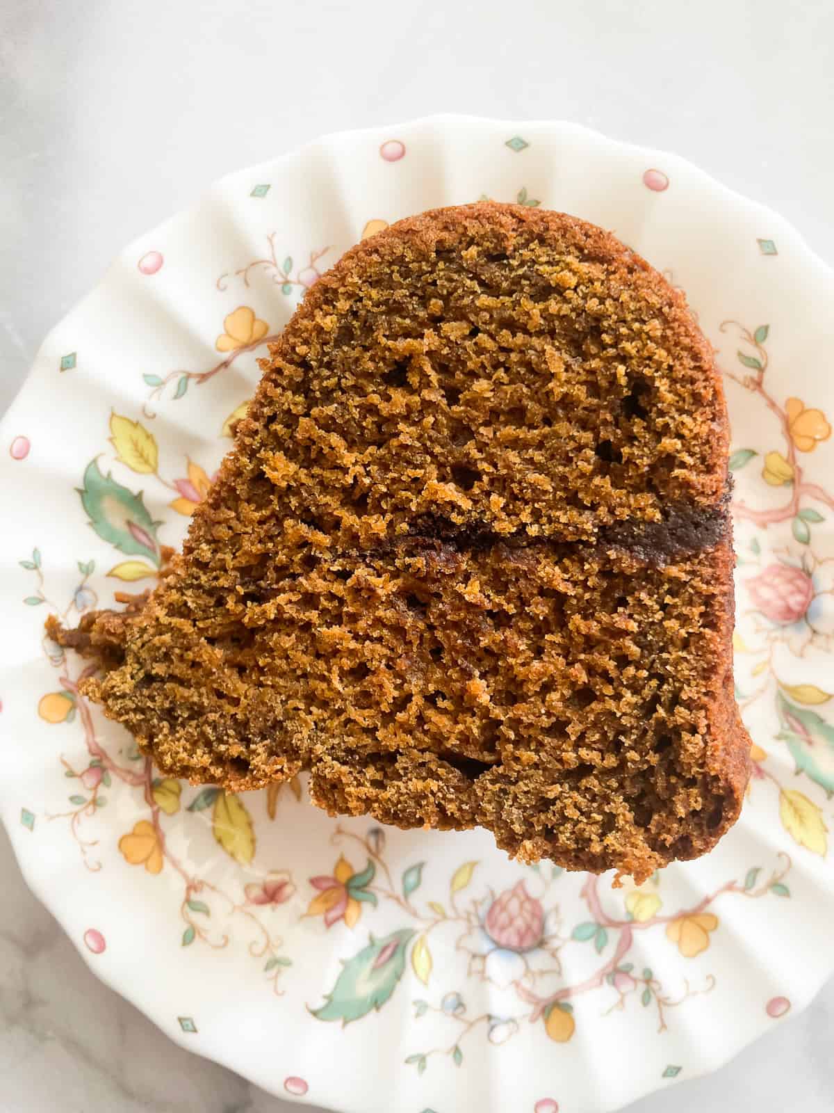 A piece of pumpkin cake on a plate.