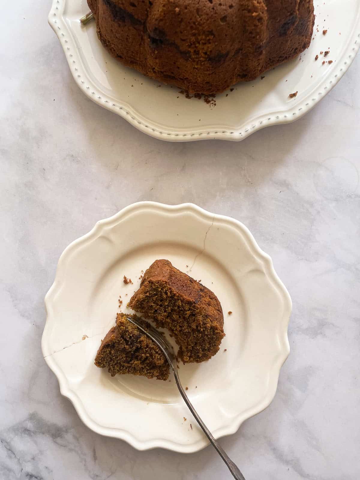 A fork cuts into a piece of pumpkin cake.