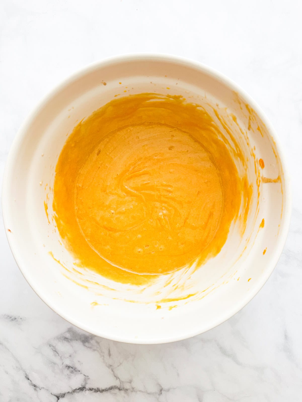 Pumpkin puree is added to creamed butter.