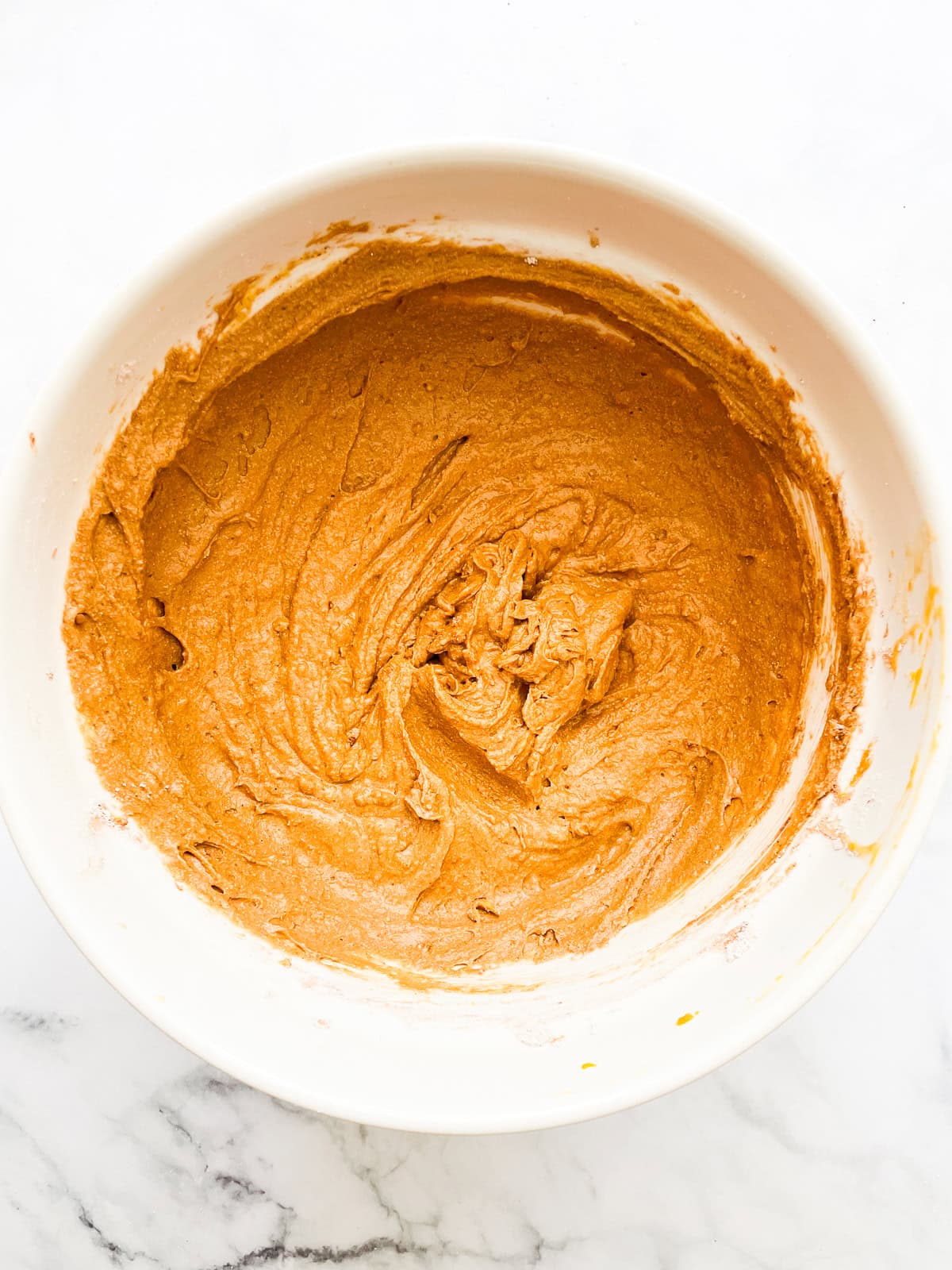 The batter for pumpkin bundt cake in a bowl.