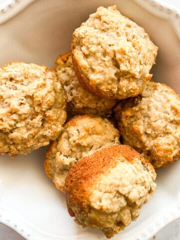 Leftover oatmeal muffins in a white bowl.