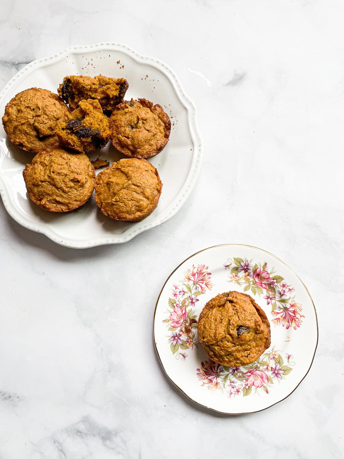 A plate of oat flour pumpkin muffins and a muffin on a plate.