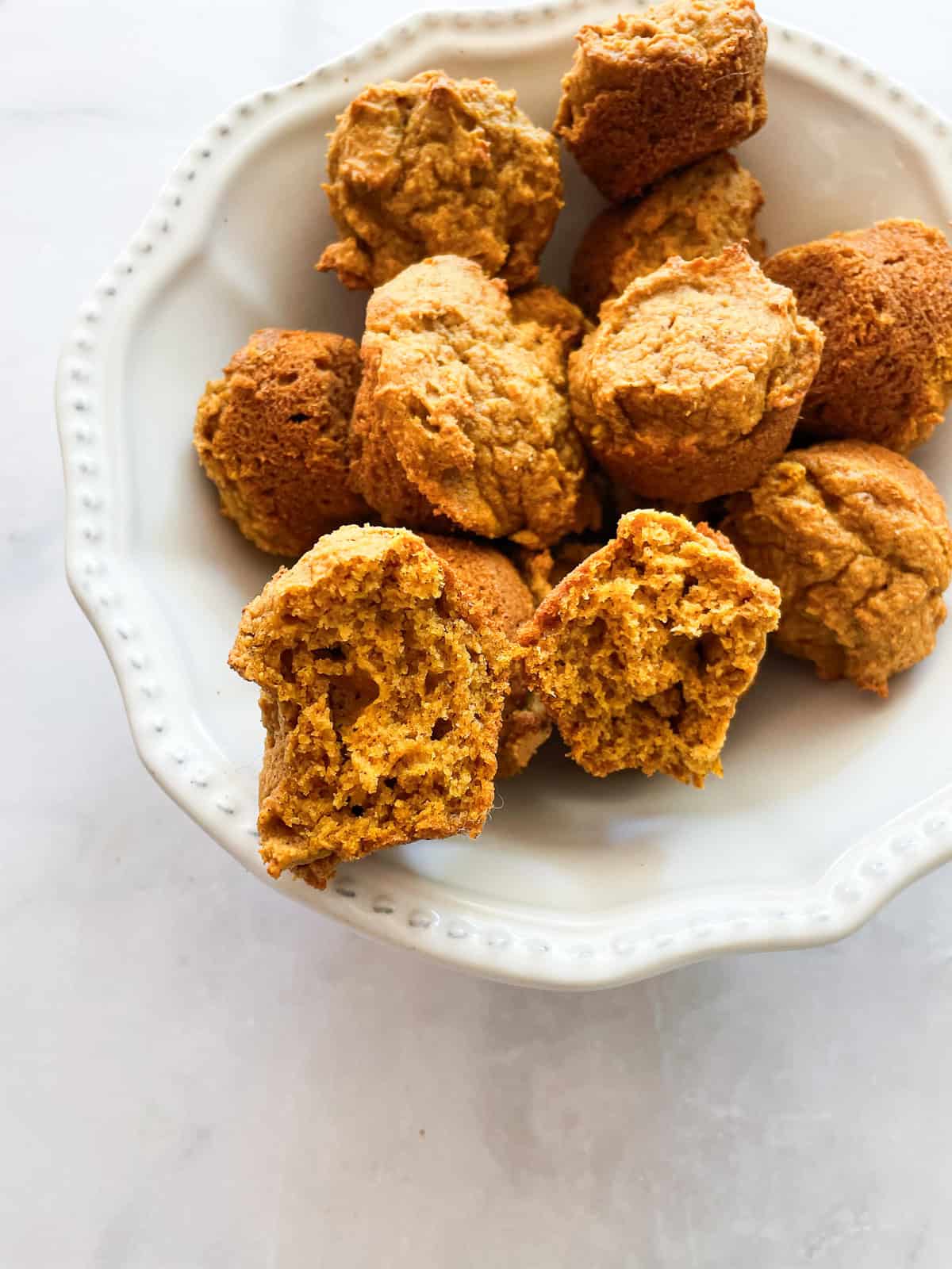 The fluffy interior of a gluten free mini pumpkin muffin.