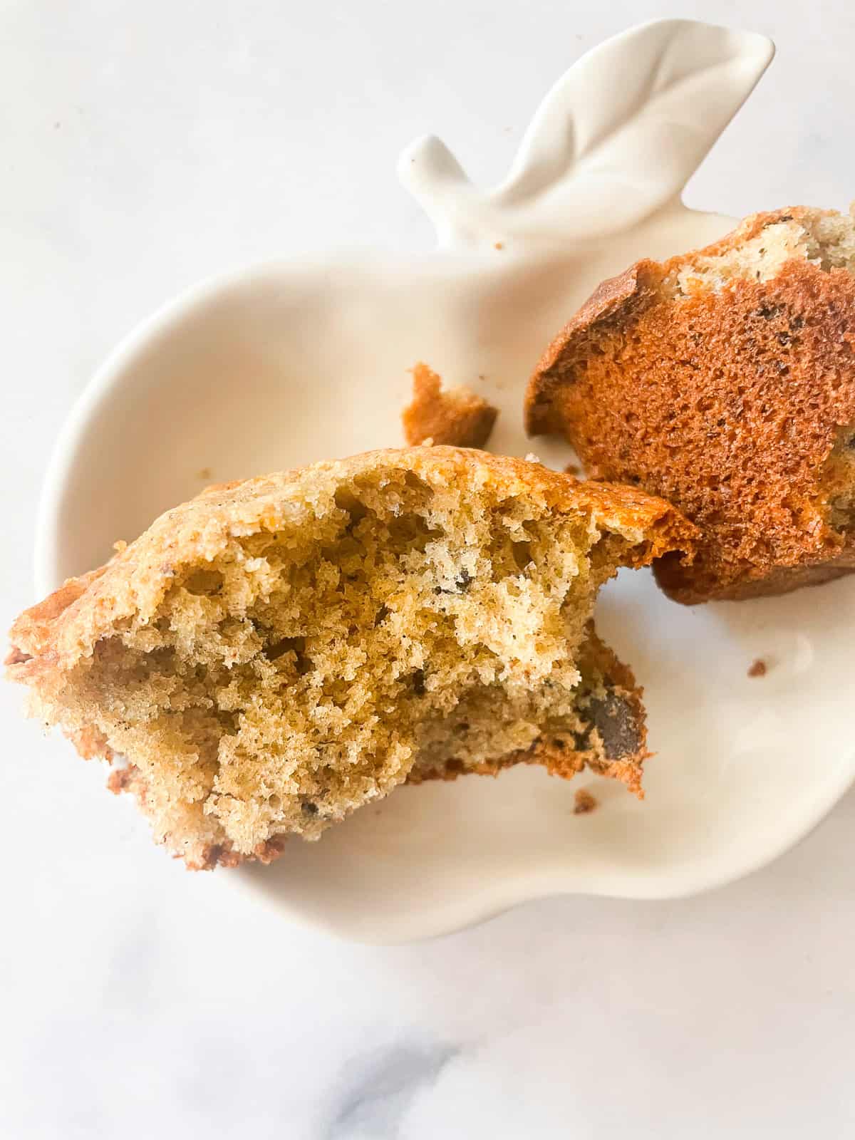 A banana muffin is cut in half to show its interior.