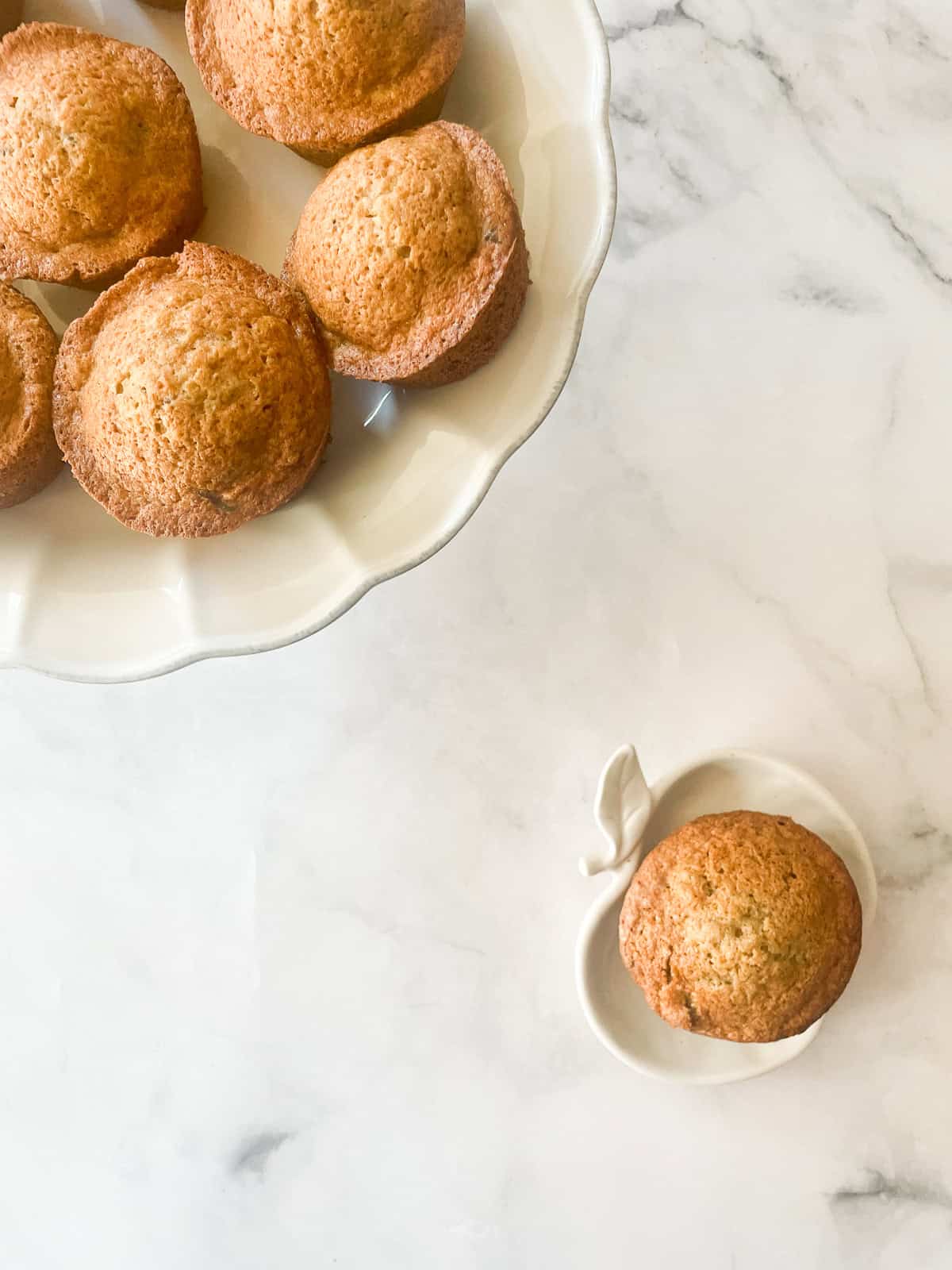 A gluten free chocolate chunk banana muffin on an apple plate.