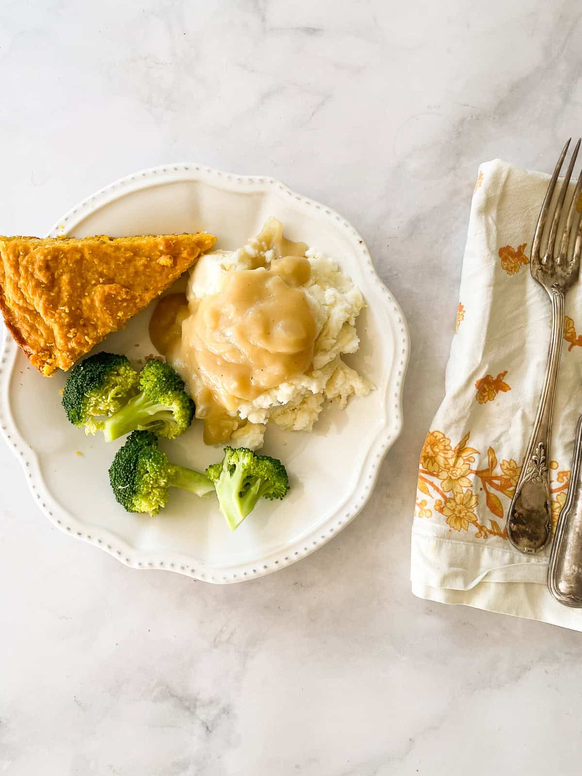 A plate of food topped with gluten free gravy.