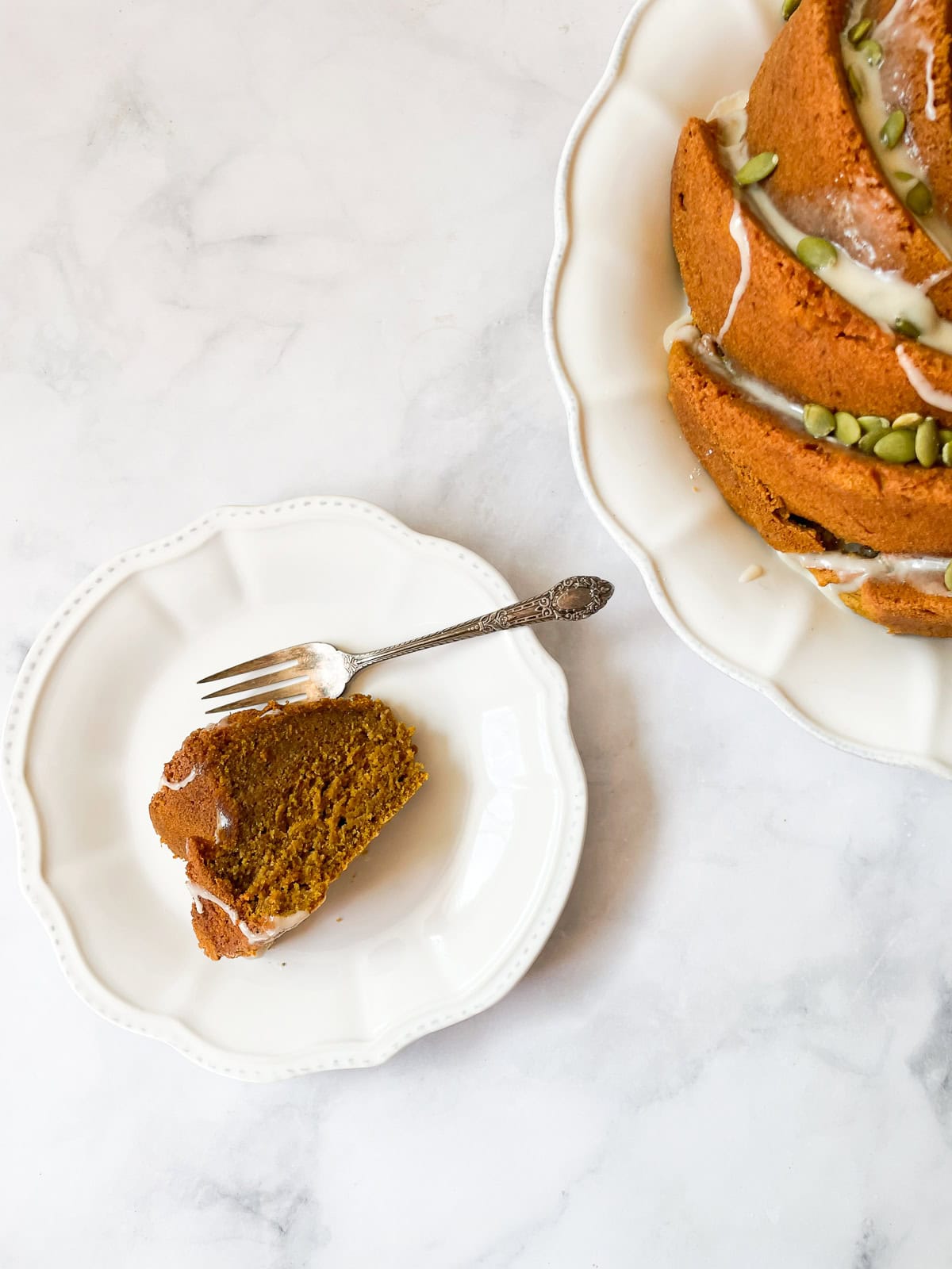 A slice of pumpkin bundt cake on a plate with fork.