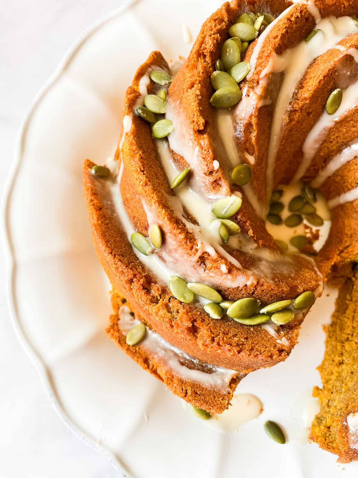 A pumpkin bundt cake with a slice cut out.