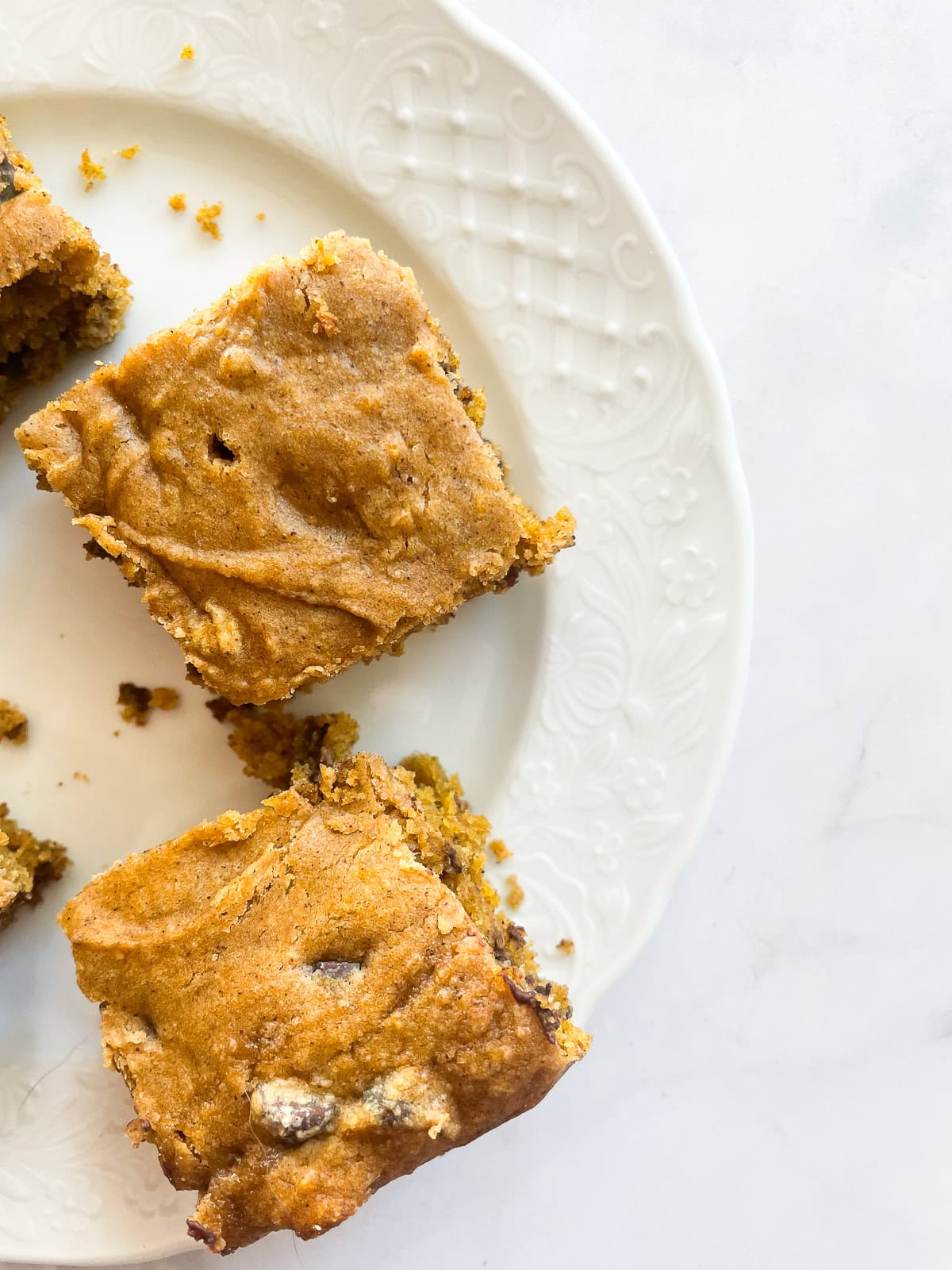 Pieces of gluten free pumpkin chocolate chip cake on a plate.