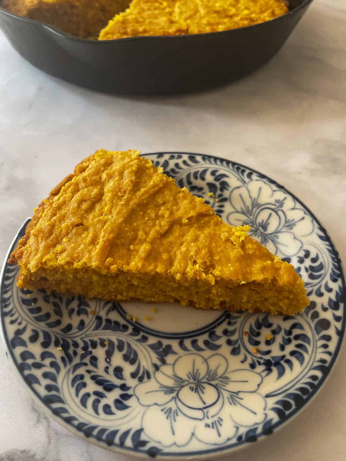 A slice of pumpkin cornbread on a plate.