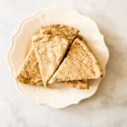 A plate holds triangles of gluten free shortbread.