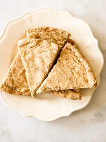 A plate holds triangles of gluten free shortbread.