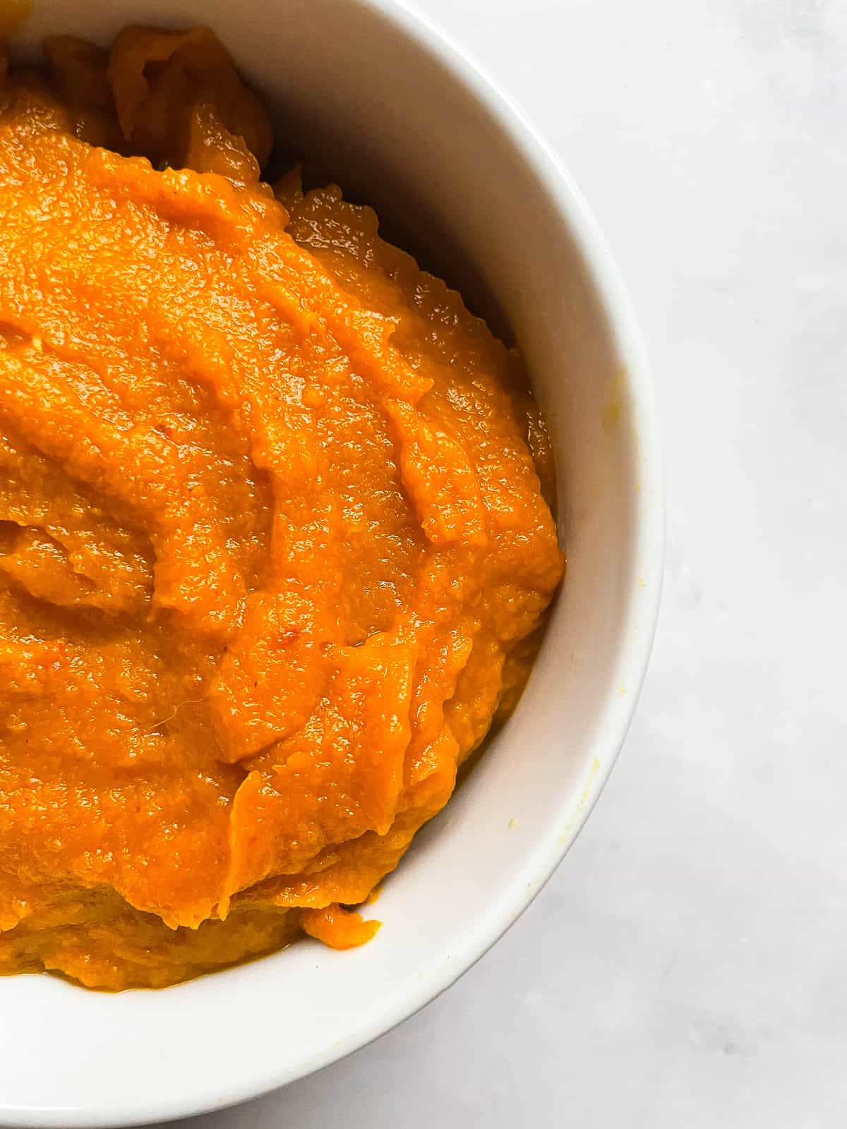 Half of a bowl of pumpkin puree.