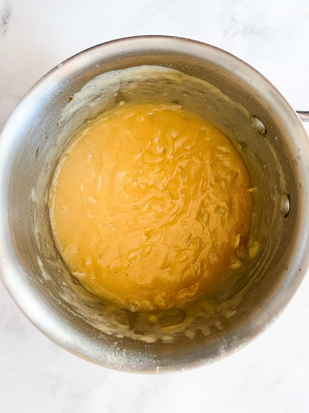 Easy gluten free gravy is an essential addition to the holiday table! Try this luxurious gravy on mashed potatoes, turkey, vegetarian dishes, and more. A pot of gluten free gravy.