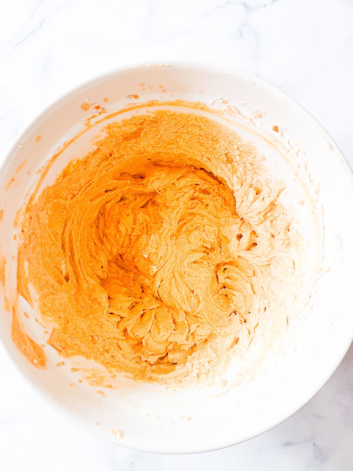 Pumpkin bundt cake batter in a bowl.