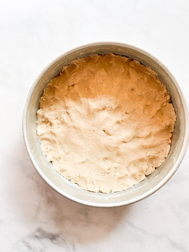 Shortbread dough pressed into a pan.