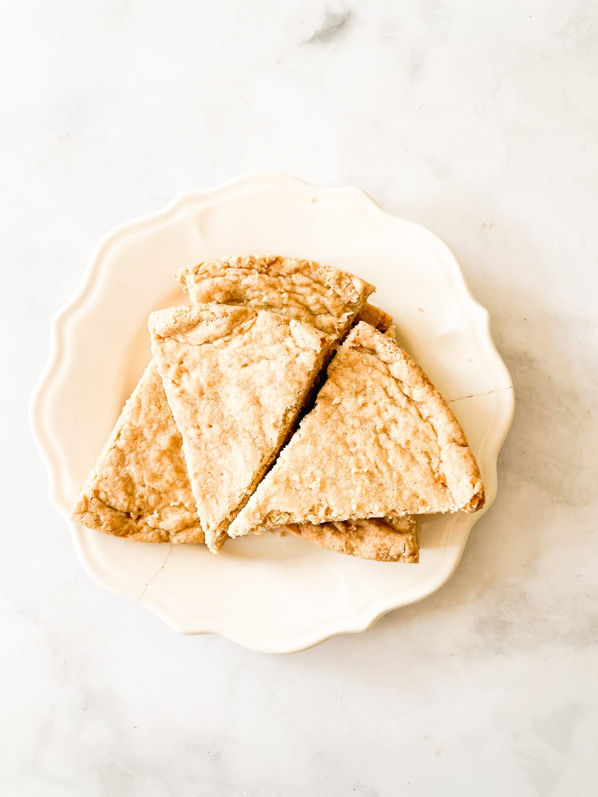 A plate holds triangles of gluten free shortbread.