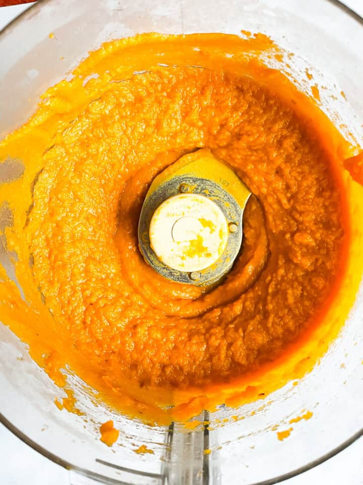 A food processor with pumpkin puree.