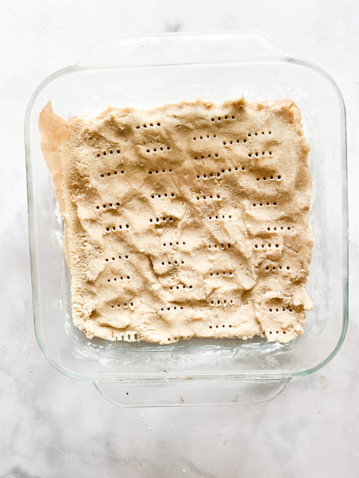 Use a fork to prick holes in the top of shortbread dough.