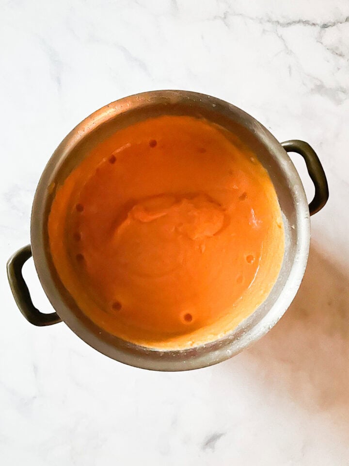 Pureed sweet potato and coconut soup in a pot.