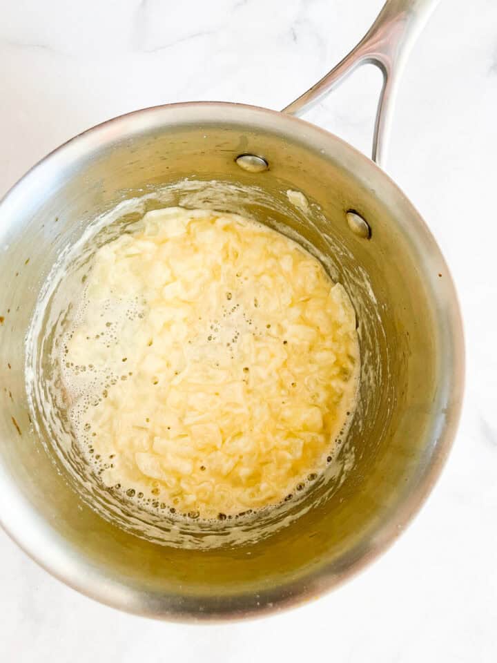 Flour is added to onions for a roux.