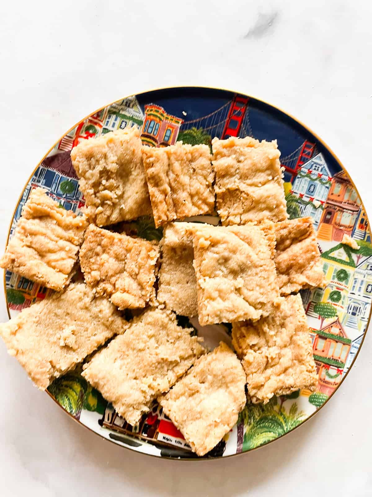 Squares of maple shortbread on a decorative plate.