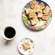 A plate of maple shortbread and a cup of coffee.